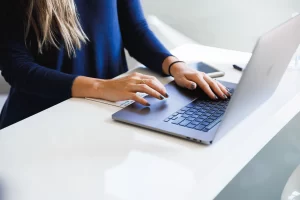 a woman typing in laptop